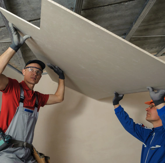 worker installing drywall